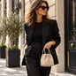 Preview: Vimoda Cleo champagne woven leather handbag styled with an elegant outfit, model and background created with AI