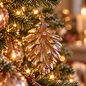 Preview: Christmas Inspirations brown pinecone ornament hanging on a modern Christmas tree, background created with AI