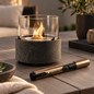 Preview: Tenderflame Pen Torch Lighter Feuerzeug in bronze neben einem Tischfeuer auf der Terrasse