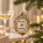 Preview: Vondels Press for Champagne glass ornament hanging from a fir branch with champagne glass behind