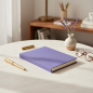 Preview: Trixi Gronau MAZZI A5 Notizbuch Kanuba lila auf Marmor-Schreibtisch mit Lavendel und Messingfüller