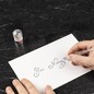 Preview: Schreibprobe mit Jacques Herbin Gris Nuage auf weißem Papier, Aluminiumdose daneben