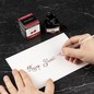Preview: Kalligrafie mit Jacques Herbin Rouge Grenat Tinte und Glasfeder auf weißem Papier