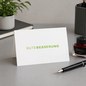 Preview: Trixi Gronau GUTE BESSERUNG get-well greeting card, B6 landscape in white paper with the words GUTE BESSERUNG in large fresh-green sans-serif capitals, GUTE in fine weight and BESSERUNG in heavier weight, centered almost across the full card width. On a l