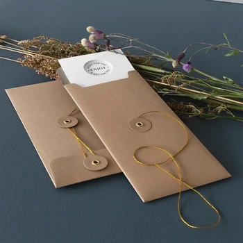 Preview: Zwei Embacollage Geschenkumschläge JOY Nature in natur mit goldfarbener Kordel auf dunkelblauem Grund mit Trockenblumen, TRIXI GRONAU Hamburg