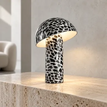 Preview: Sompex SVAMP LEOPARD glowing with warm white light on a pale natural stone sideboard in a minimalist modern interior