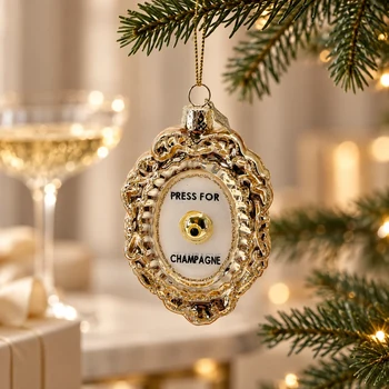 Preview: Vondels Press for Champagne glass ornament hanging from a fir branch with champagne glass behind