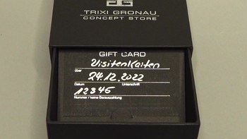 Preview: Opened black gift box with Trixi Gronau gift card in business card format, silver hot foil embossing