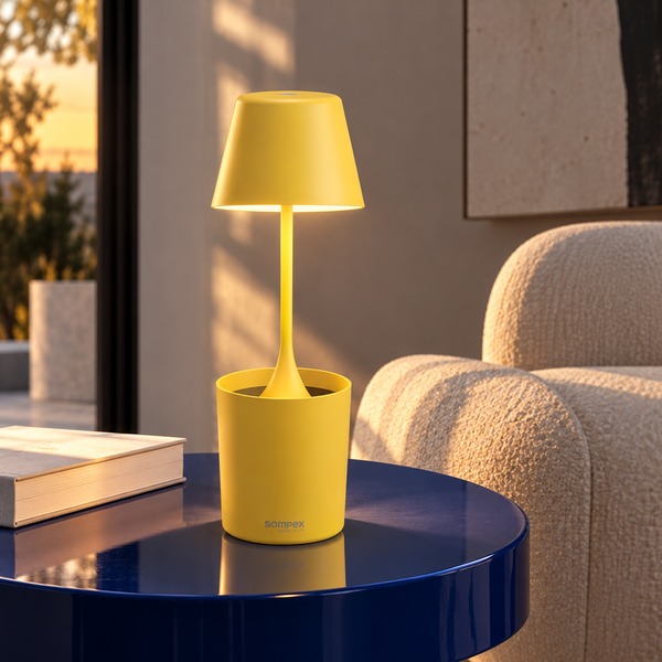 AI-generated living room scene with yellow Sompex PEEKY rechargeable lamp on a dark blue side table