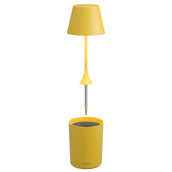 Yellow Sompex PEEKY table lamp with removable metal soil spike above charging base