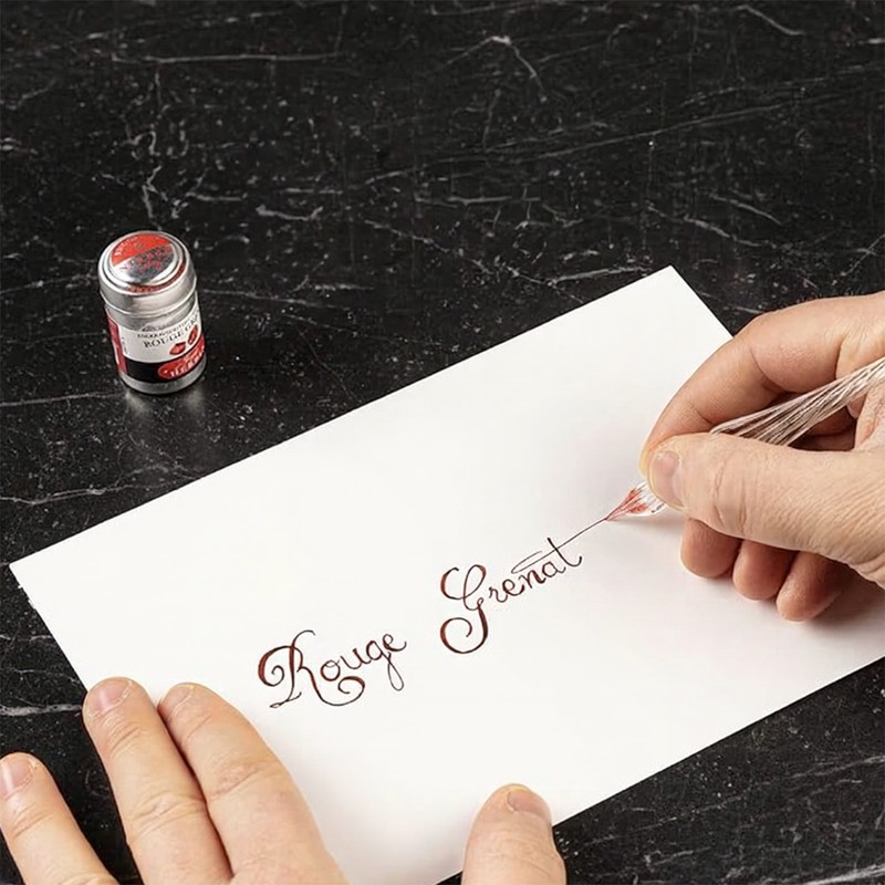 Kalligrafie mit Jacques Herbin Rouge Grenat Tinte und Glasfeder auf weißem Papier
