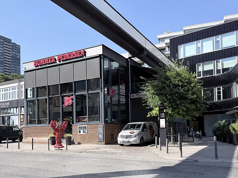 Hummer Pedersen in Hamburg seen from outside, a red lobster in front of the glass pavilion