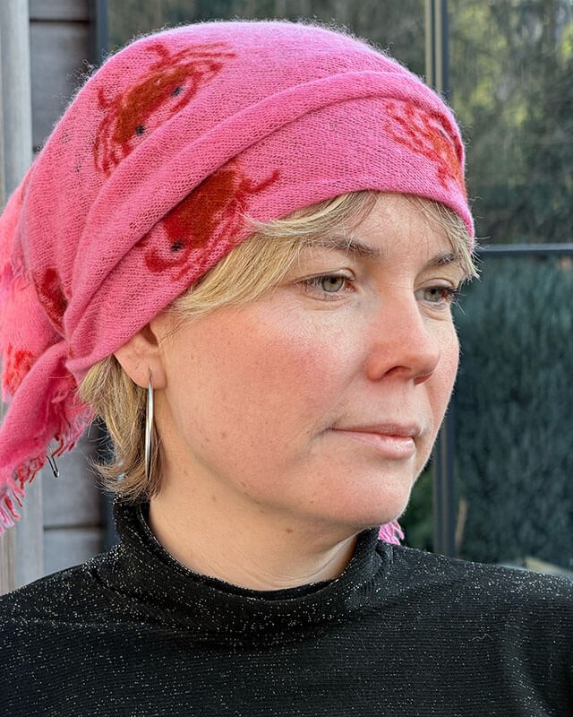 Woman wearing a pink cashmere scarf by Cute Stuff