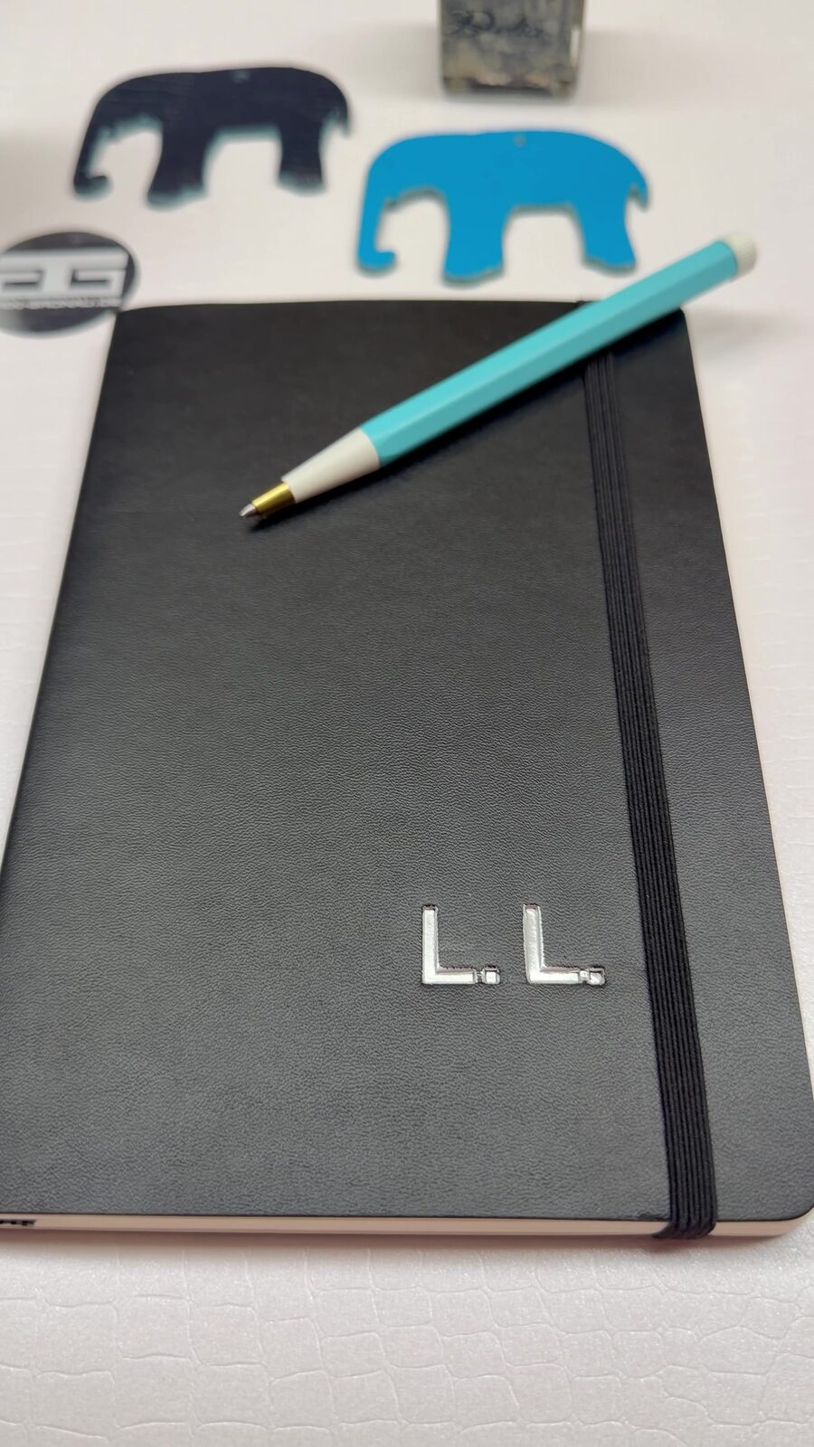 Black notebook with silver hot foil stamped initials from the TRIXI GRONAU atelier