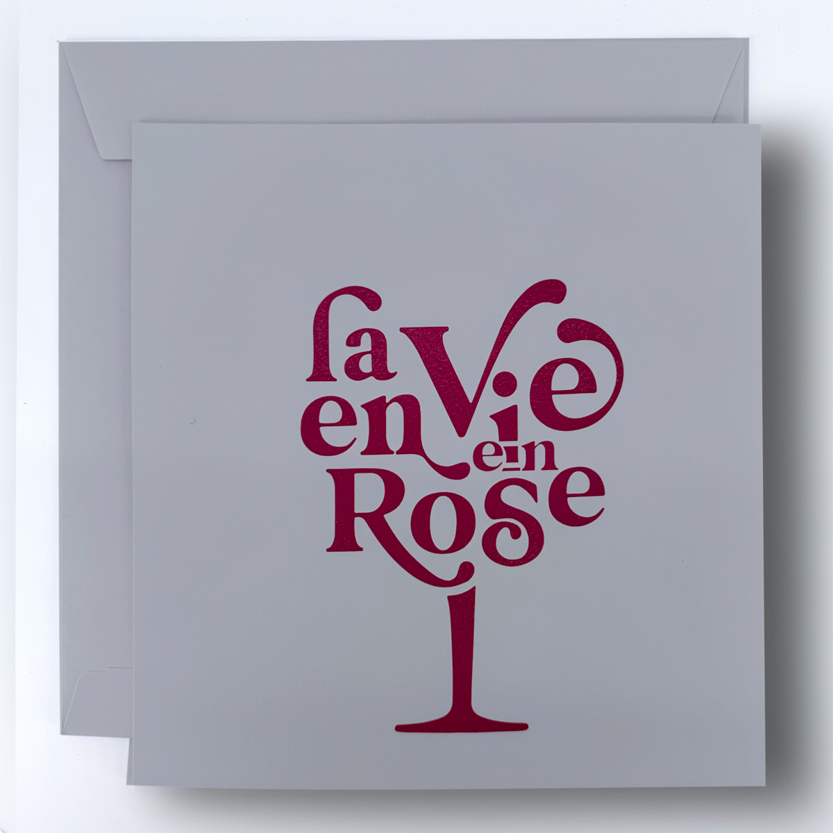 La vie en rose invitation card with red raised printing on light card stock
